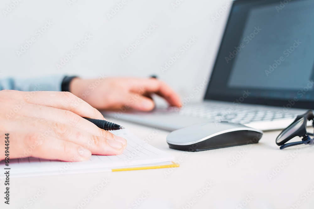 Businessmen hands using laptop on desk.