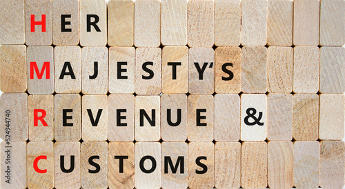 HMRC her majestys revenue and customs symbol. Concept words HMRC her majestys revenue and customs on blocks on beautiful wooden background. Business HMRC revenue and customs concept. Copy space. photo