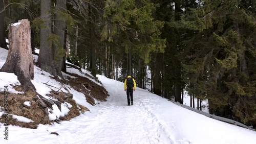 Lone man walking through snow. Mountain expedition. Epic Aerial steady view