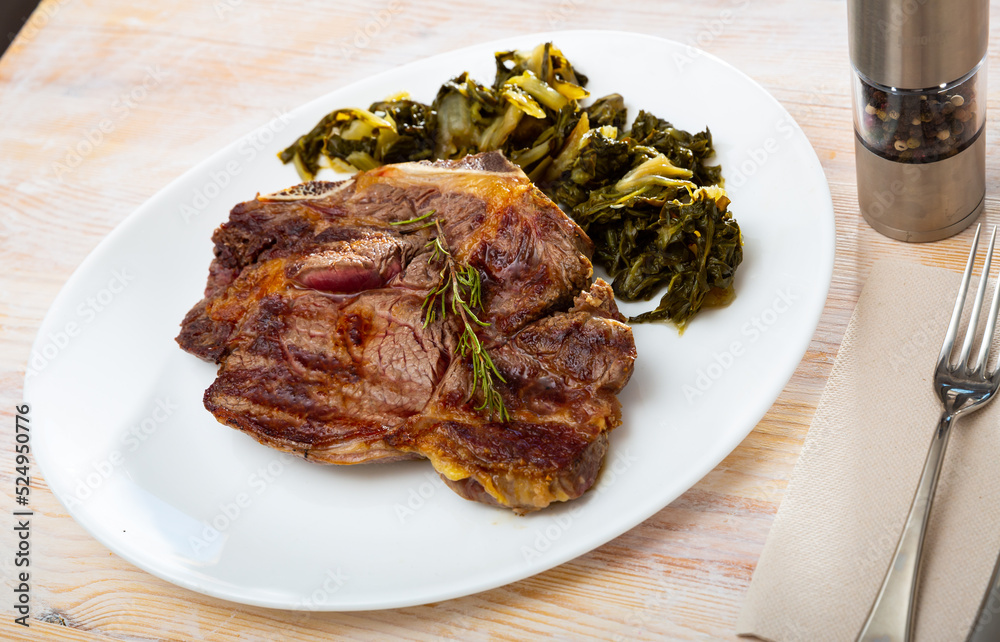 Barbecue veal steak served with marinated chopped chard leaves