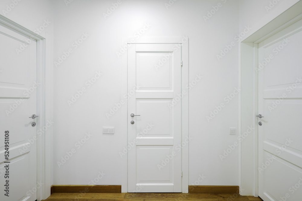 White interior doors in the white corridor