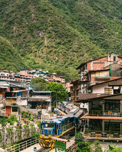Train station at Aguas Calientes village Cusco Peru gateway to Machu Picchu Scenic town in the Andes with railway, tourism and mountains surrounding the valley