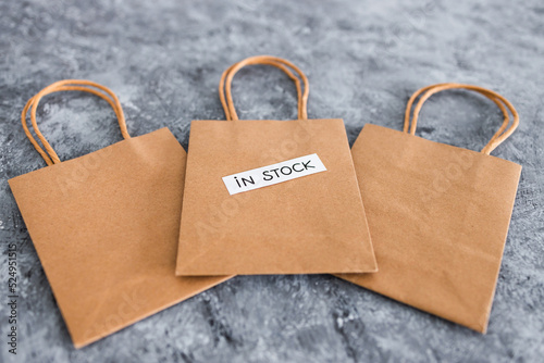 In stock text on top of shopping bags, shopping and retail