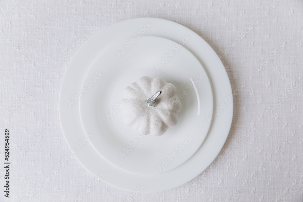 Thanksgiving set. Table setting, white plates with pumpkin, mockup, top view Thanksgiving set. Table setting, white plates with pumpkin, mockup, top view
