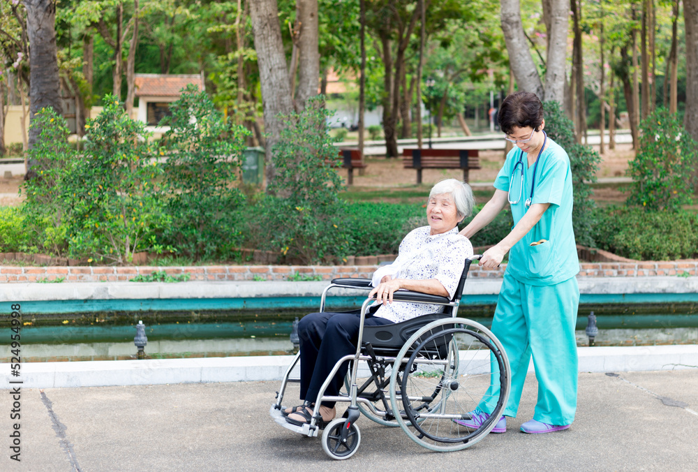 Asian health worker drive a wheelchair of old patient, happy hospital, rehabilitation activity Asian health worker drive a wheelchair of old patient, happy hospital, rehabilitation activity