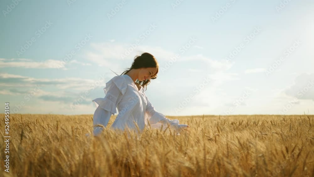 carefree woman is running on ripe rye ears in agricultural fields in sunny summer day, slow motion carefree woman is running on ripe rye ears in agricultural fields in sunny summer day, slow motion