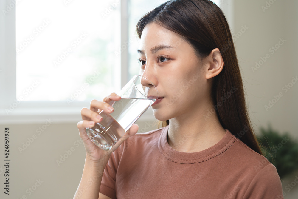 Clean freshwater concept. Woman drink mineral water in the morning for good health. Clean freshwater concept. Woman drink mineral water in the morning for good health.