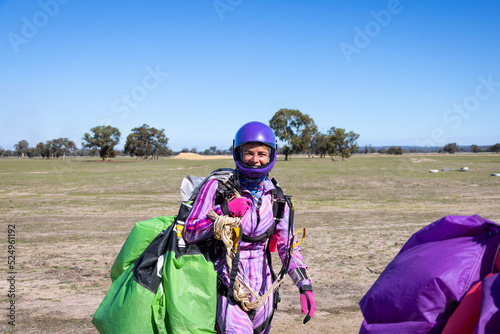 elated skydiver returning from jump at country drop zone