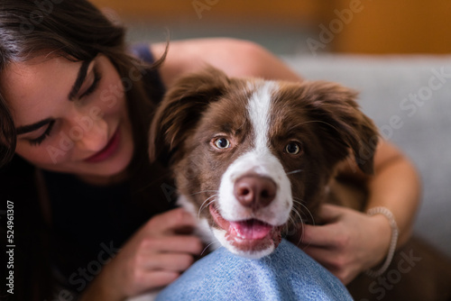 young women with pet puppy, at home photo