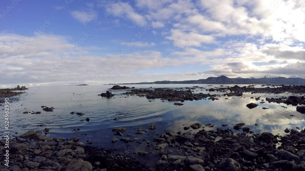 A panning time lapse shot of the ocean waters, rocks, and sky of Kodiak Island Alaska. A panning time lapse shot of the ocean waters, rocks, and sky of Kodiak Island Alaska.