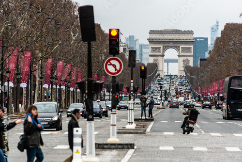 traffic in the city in the champs elysees paris with arch of triumph