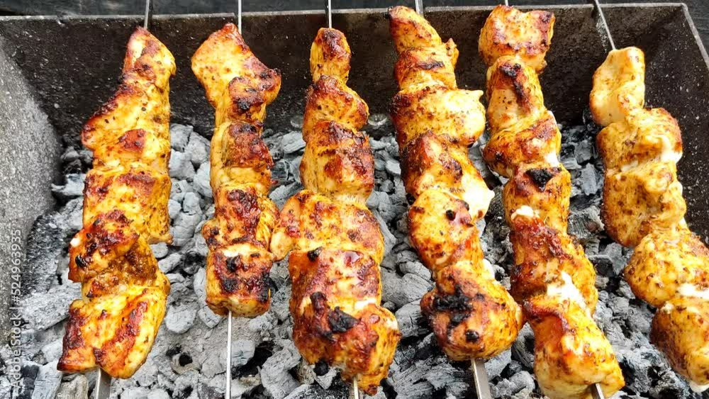 Close-up of cooking food on the barbecue. The process of grilling kebabs.