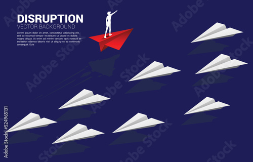 Silhouette of businessman standing and point forward on red origami paper airplane go different way from group of white. Business Concept of disruption and vision mission.