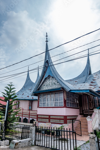 A view of traditional Minangkabaunese house called Rumah Gadang with beautiful colorfull wall and unique facade photo