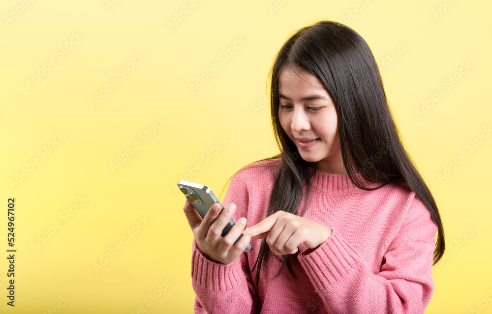 great mobile deals smartphone in hand Interact emotionally with the new app. happy woman standing alone over yellow studio background great mobile deals smartphone in hand Interact emotionally with the new app. happy woman standing alone over yellow studio background