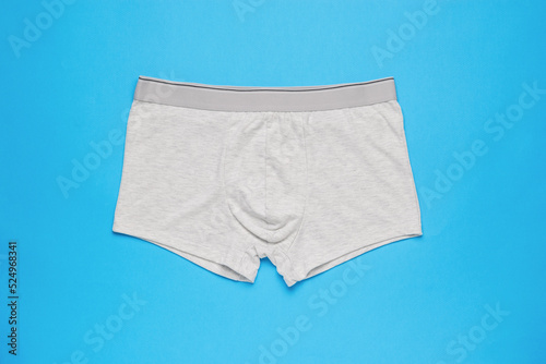 Light men's underpants on a light blue background. Minimal concept of men's underwear.