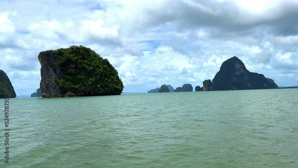 Phangna Bay near the Island of Phuket Thailand. Lovely rock in the middle of the ocean surrounded by mountains Phangna Bay near the Island of Phuket Thailand. Lovely rock in the middle of the ocean surrounded by mountains