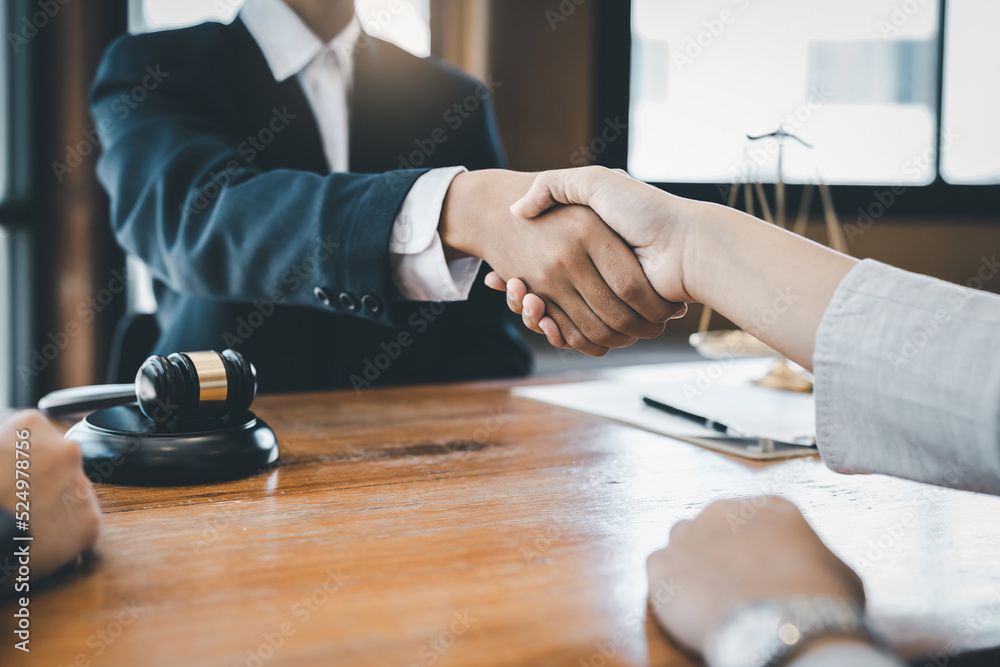 Business team and lawyer shaking hand after discussing about agreement contract. Law, legal services, advice, Justice concept