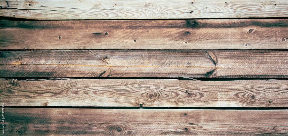 Dark background of wooden planks, burned and folded horizontally. The boards are old, damaged. Sepia picture. Dark background of wooden planks, burned and folded horizontally. The boards are old, damaged. Sepia picture.