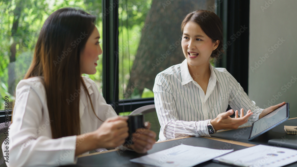 Coworker business concept, Businesswoman drinking coffee and discussing new project with colleague Coworker business concept, Businesswoman drinking coffee and discussing new project with colleague