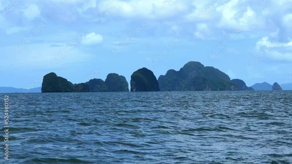 Phangna Bay near the Island of Phuket Thailand. Lovely rock in the middle of the ocean surrounded by mountains Phangna Bay near the Island of Phuket Thailand. Lovely rock in the middle of the ocean surrounded by mountains