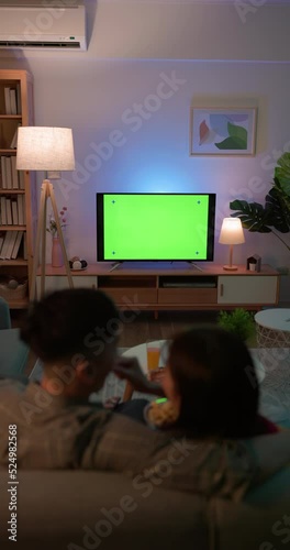 couple watch green screen TV