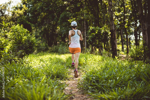 Fototapeta Naklejka Na Ścianę i Meble -  Trail runner running in summer forest trail