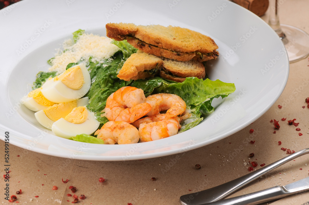 caesar salad with shrimp in a traditional serving in a white plate, macro photo
caesar salad with shrimp in a traditional serving in a white plate, macro photo