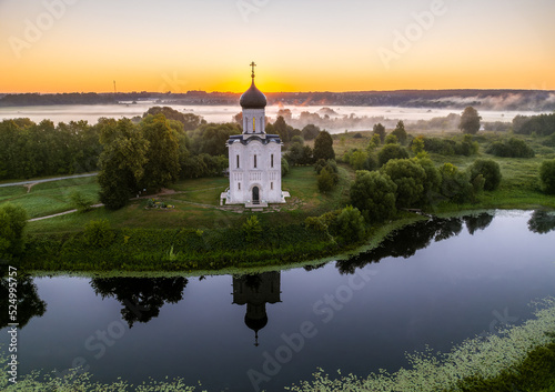 Sun is rising over the Church of the Intercession on the Nerl river (Vladimir region, Russia)