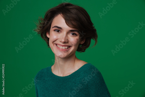 Young white woman wearing sweater laughing and looking at camera