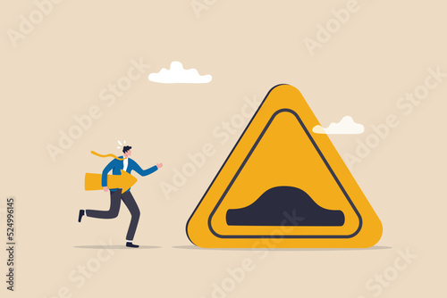 Business slow down due to obstacles, difficulty or speed limit, beware of crisis ahead or recession, economic depression concept, businessman running with arrow to find speed bump slow down sign.