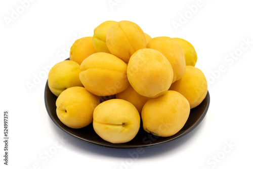 Ripe apricot isolated on white background. Fresh and juicy apricots on the plate. Organic food. close up