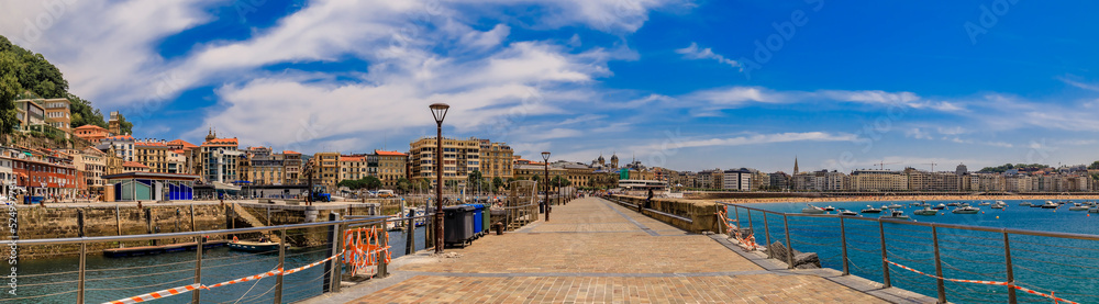 Panorama of La Concha bay and beach from a pier in San Sebastian Donostia with the city coastline and waterfront hotels in the Basque Country, Spain