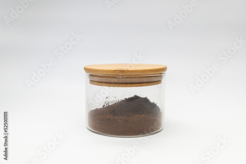 Ground coffee in a jar on a white background