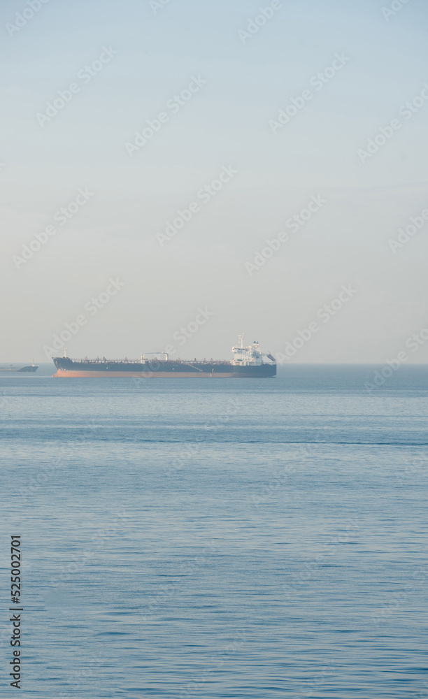 View of blue Aegian sea with chemical gas - oil tanker in calm waters - transportation of fossils to diverse conutries - useful photo for energy csysis and enviromental impoact of fossil power