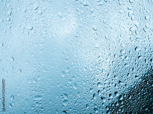 Water drops on glass background texture blue 