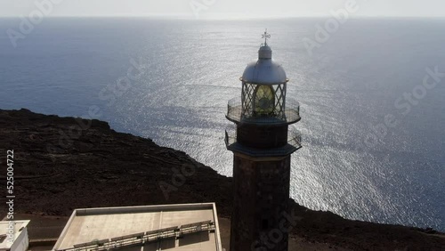 aerial shot in orbit of the Orchilla lighthouse on the island of El Hierro, on a sunny day. photo