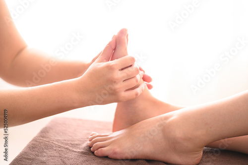 Image of an esthetician and the foot of an esthetician.