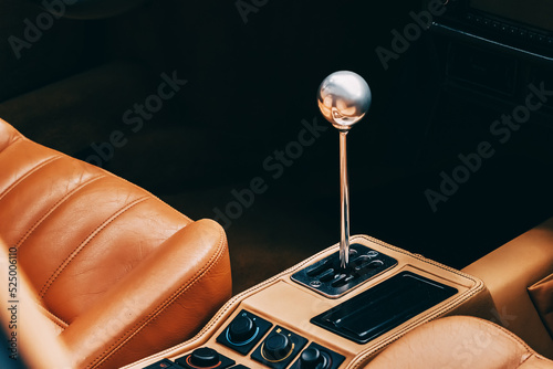 the gearshift lever in the interior of a luxury car with leather upholstery seats photo