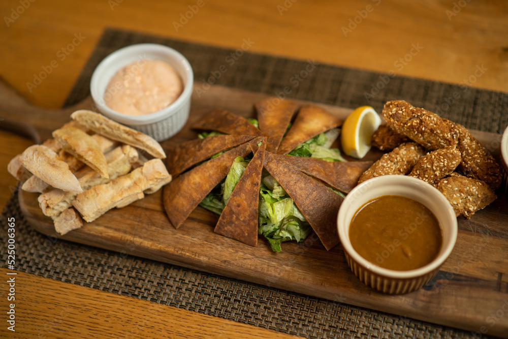 Close up image of served baba ghanoush meal on wooden board. Close up image of served baba ghanoush meal on wooden board.