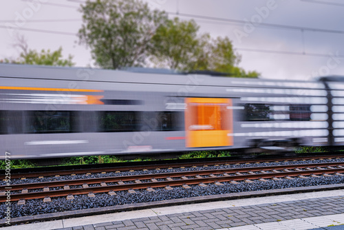 A modern high speed intercity train carries passengers. Public transport and technology. Blur in motion.