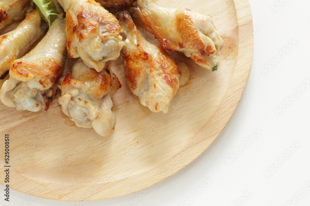 Barbecue chicken drumsticks on wooden plate with copy space Barbecue chicken drumsticks on wooden plate with copy space