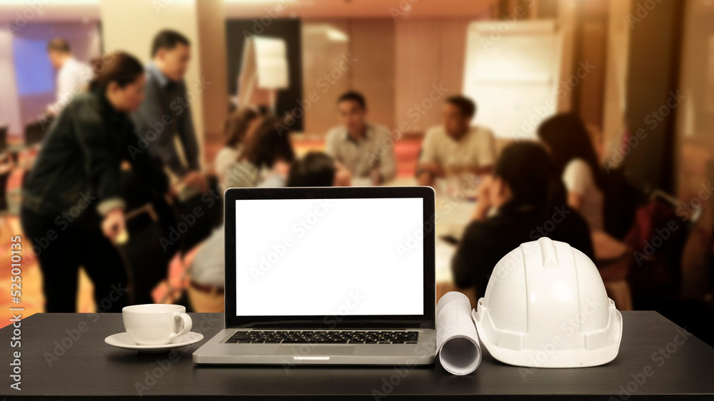 Front view of laptop computer and office construction on table in office blurred background.Architect concept.. Front view of laptop computer and office construction on table in office blurred background.Architect concept..