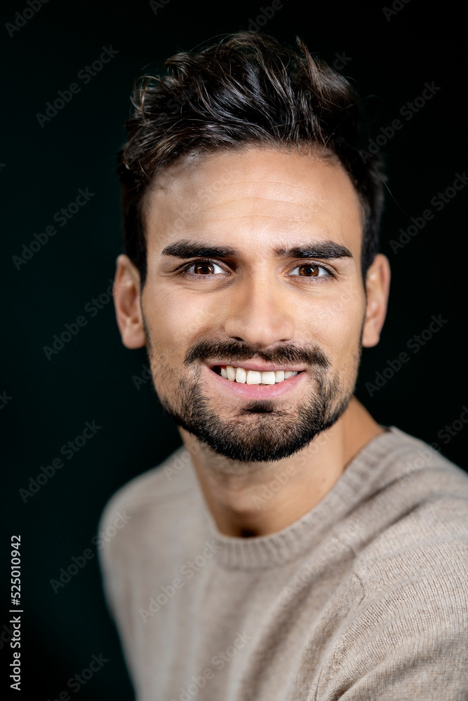 Smiling businessman against black background Smiling businessman against black background