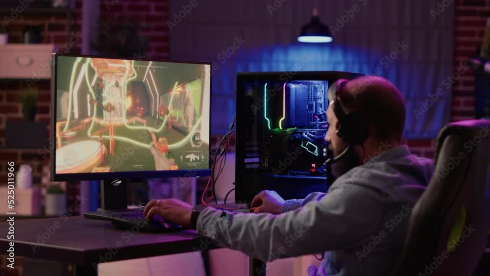 Static tripod shot of man playing online first person shooter angry after losing online competition on gaming pc. Streamer unhappy and disappointed after failing level in action video game challenge. Static tripod shot of man playing online first person shooter angry after losing online competition on gaming pc. Streamer unhappy and disappointed after failing level in action video game challenge.