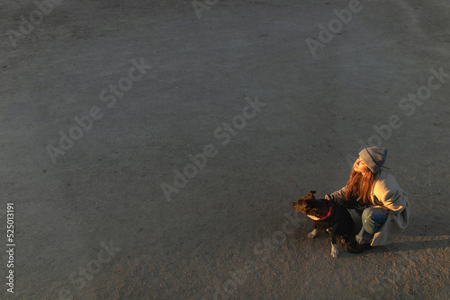 Young woman having fun with her american stanford dog photo