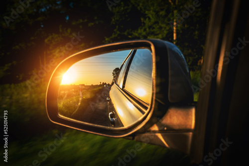 Road trip car mirror. Sun, highway car road reflection in mirror. Summer holidays trip concept. © Maksym