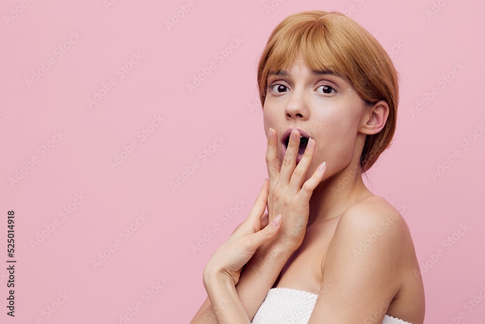 horizontal photo with an empty space of a shocked, surprised woman with perfect skin, standing on a pink background with her mouth wide open and covering it with her hand, looking into the camera horizontal photo with an empty space of a shocked, surprised woman with perfect skin, standing on a pink background with her mouth wide open and covering it with her hand, looking into the camera