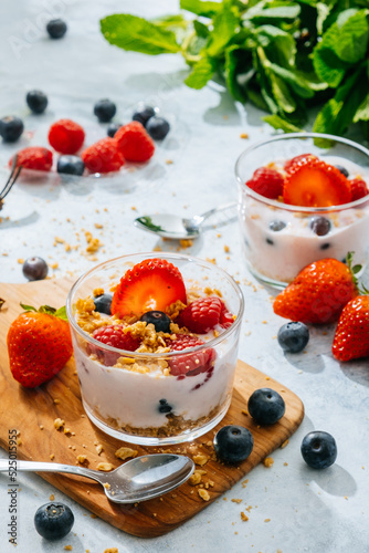 Strawberries and berries served with fresh yogurt photo