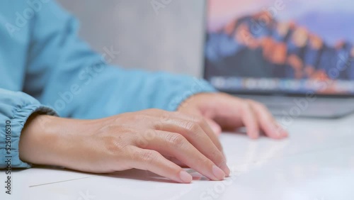 An expression of thoughtful reaction, by lightly tapping the table with your fingers. There is a computer behind the scenes.
